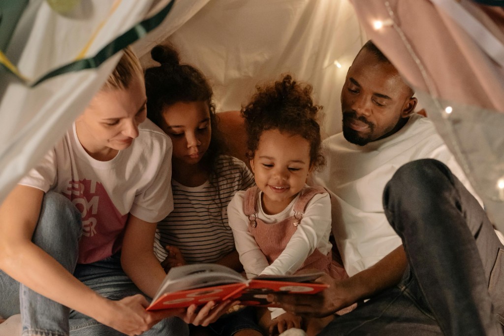 Parent and child talking in a tent