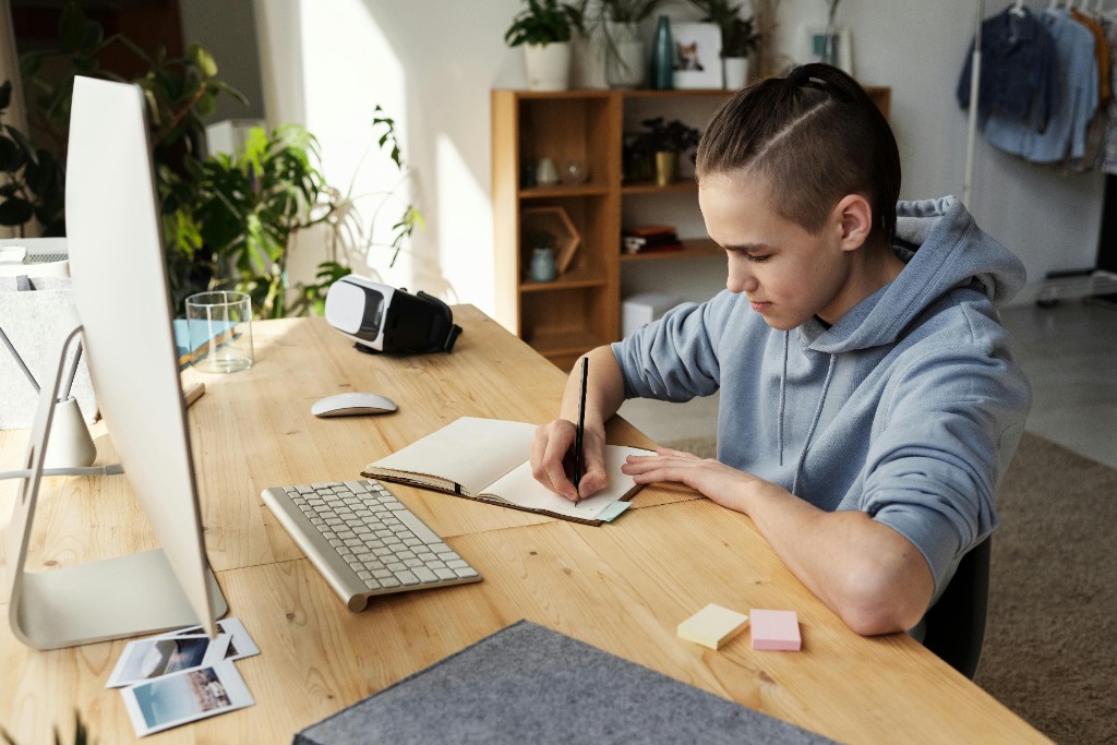 A teen at a desk